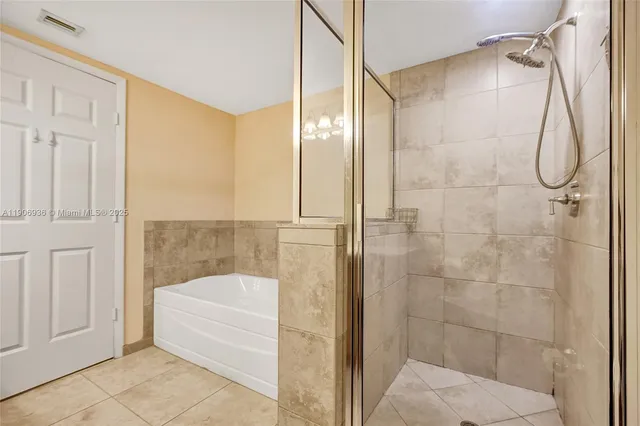 a bathroom with a glass shower door