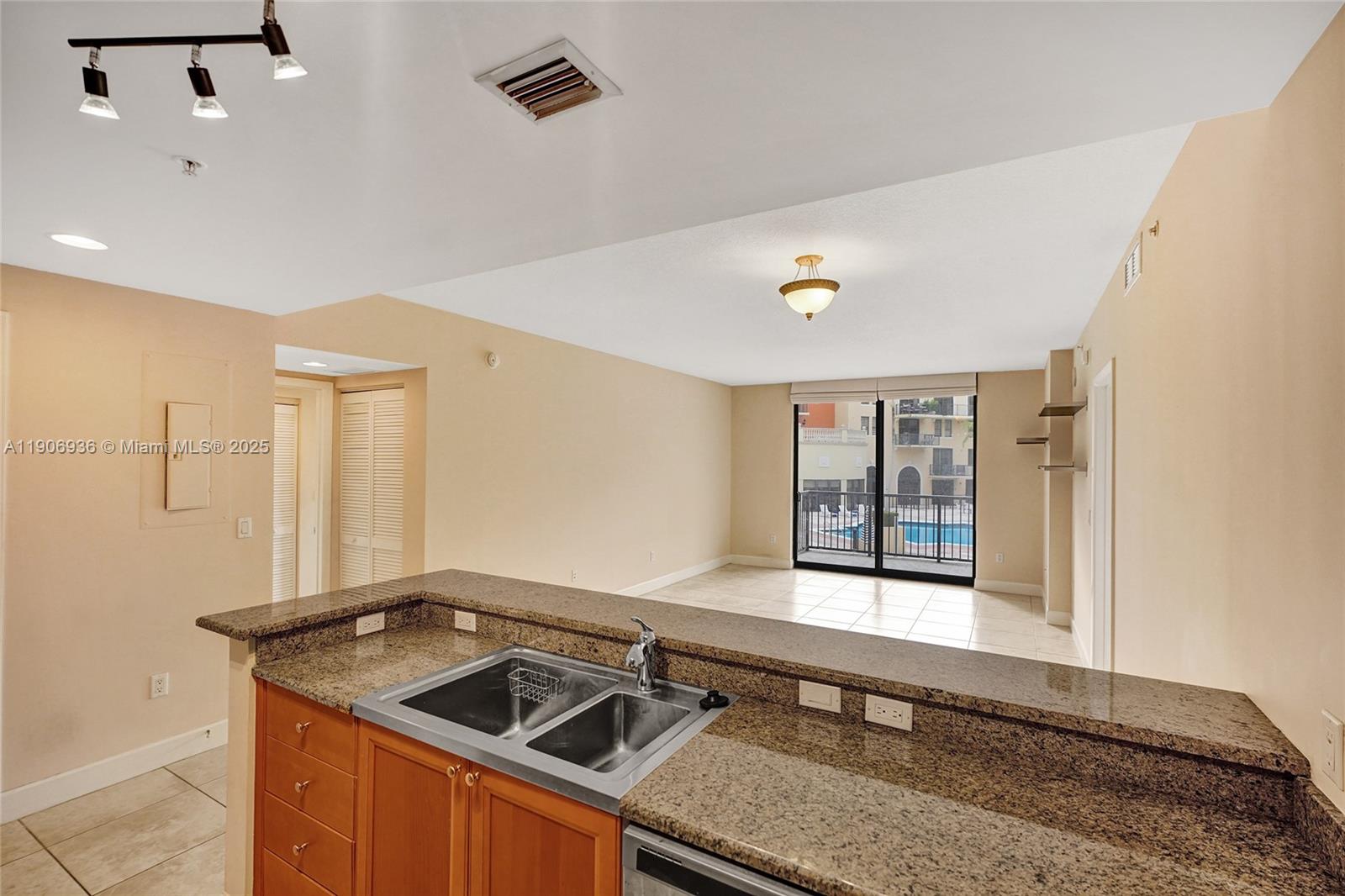 55 Merrick Way, Unit 619 Coral Gables, FL 33134 - Photo 8 of 40 a kitchen with a sink and a stove top oven