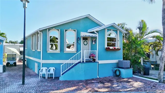 a front view of a house with plants