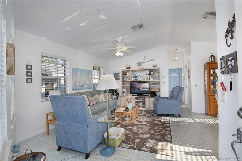 10725 South Ocean Drive, Unit 214 Jensen Beach, FL 34957 - Photo 12 of 90 a living room with fireplace furniture and a flat screen tv