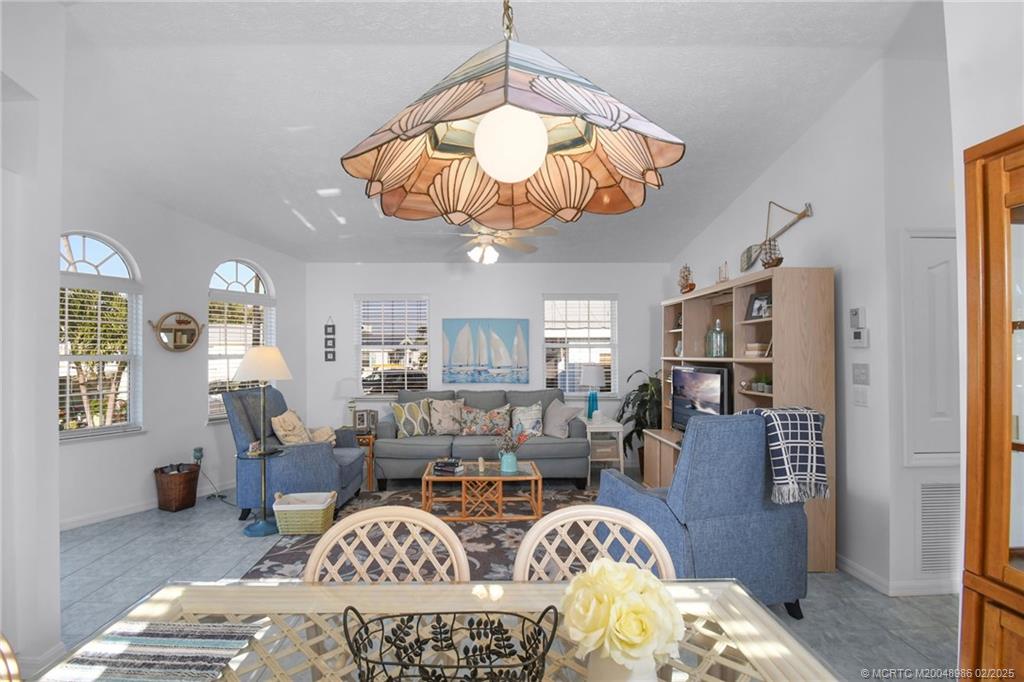 10725 South Ocean Drive, Unit 214 Jensen Beach, FL 34957 - Photo 16 of 90 a view of a livingroom with furniture and chandelier