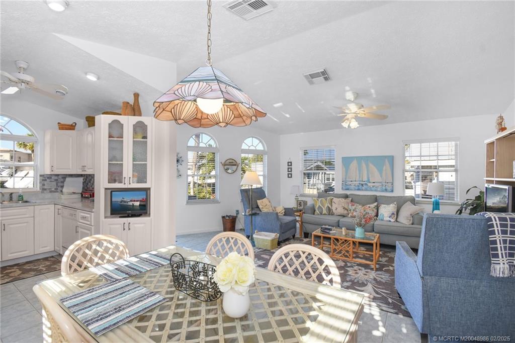 10725 South Ocean Drive, Unit 214 Jensen Beach, FL 34957 - Photo 17 of 90 a living room with furniture chandelier and a table