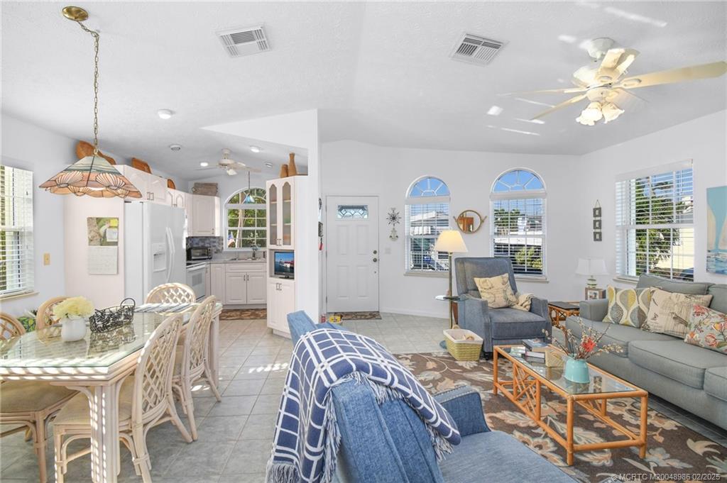 10725 South Ocean Drive, Unit 214 Jensen Beach, FL 34957 - Photo 18 of 90 a living room with furniture and a chandelier