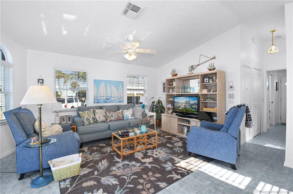 10725 South Ocean Drive, Unit 214 Jensen Beach, FL 34957 - Photo 19 of 90 a living room with furniture flat screen tv and a fireplace