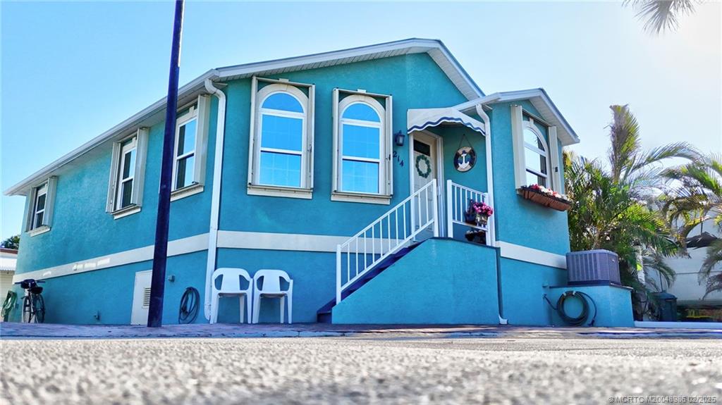 10725 South Ocean Drive, Unit 214 Jensen Beach, FL 34957 - Photo 2 of 90 a front view of a house with a yard