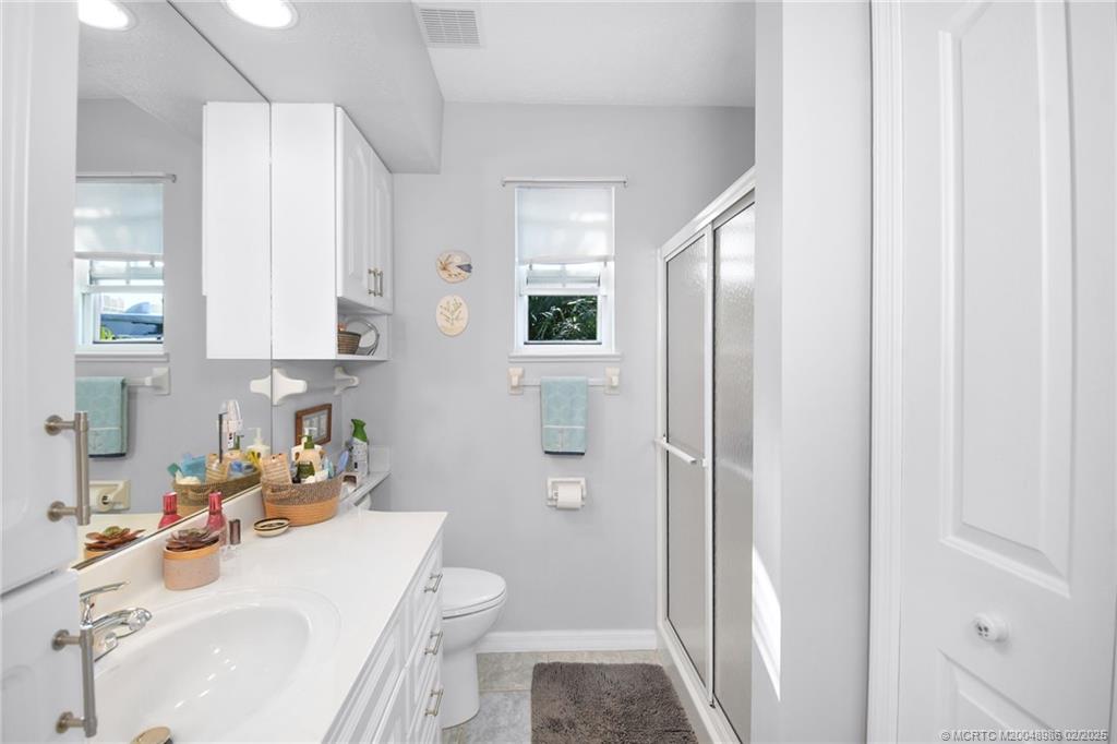 10725 South Ocean Drive, Unit 214 Jensen Beach, FL 34957 - Photo 24 of 90 a bathroom with a sink toilet and shower