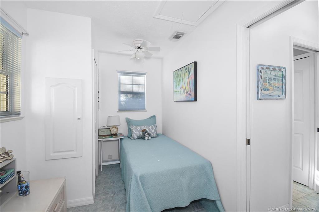 10725 South Ocean Drive, Unit 214 Jensen Beach, FL 34957 - Photo 26 of 90 a bedroom with a bed and a table in it