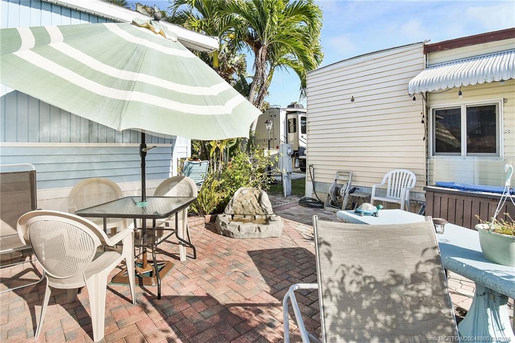 10725 South Ocean Drive, Unit 214 Jensen Beach, FL 34957 - Photo 34 of 90 a view of a chairs and table in patio