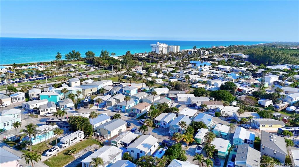 10725 South Ocean Drive, Unit 214 Jensen Beach, FL 34957 - Photo 40 of 90 an aerial view of a city with lots of residential buildings and ocean view in back