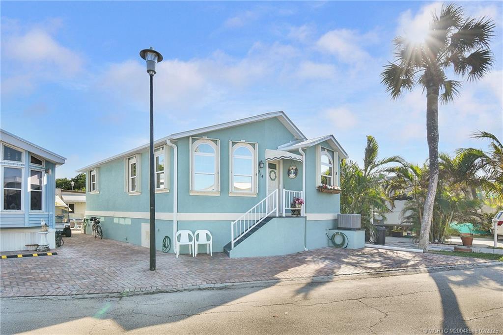 10725 South Ocean Drive, Unit 214 Jensen Beach, FL 34957 - Photo 4 of 90 a front view of a house with palm trees