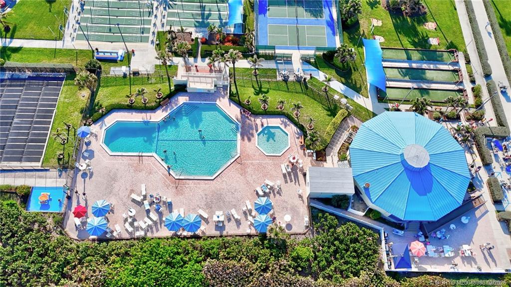 10725 South Ocean Drive, Unit 214 Jensen Beach, FL 34957 - Photo 70 of 90 an aerial view of a swimming pool patio and outdoor seating