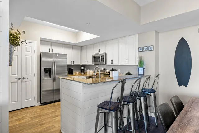 a kitchen with refrigerator and stove