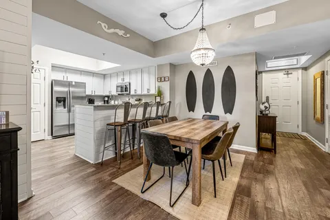 a living room with furniture ceiling fan and a wooden floor