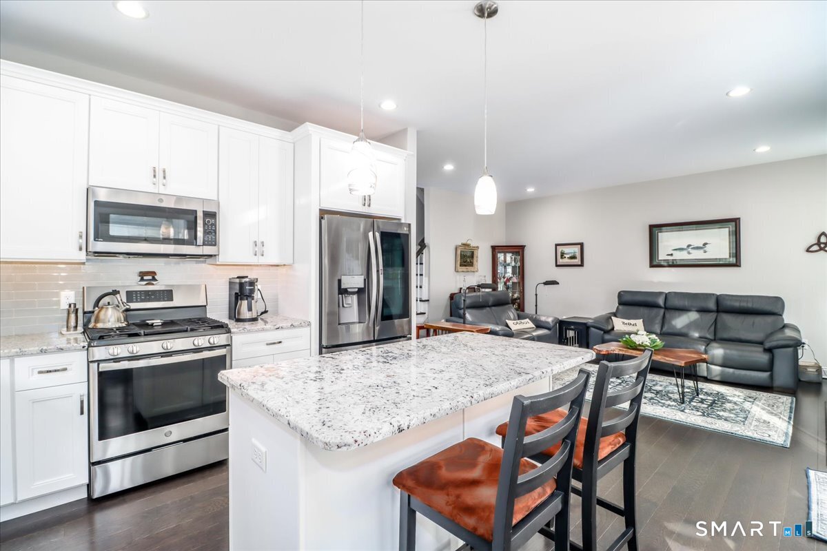 32 Hunting Ridge Lane, Unit 32 Bethel, CT 06801 - Photo 15 of 39 a kitchen with stainless steel appliances granite countertop a stove a sink a microwave a refrigerator and cabinets