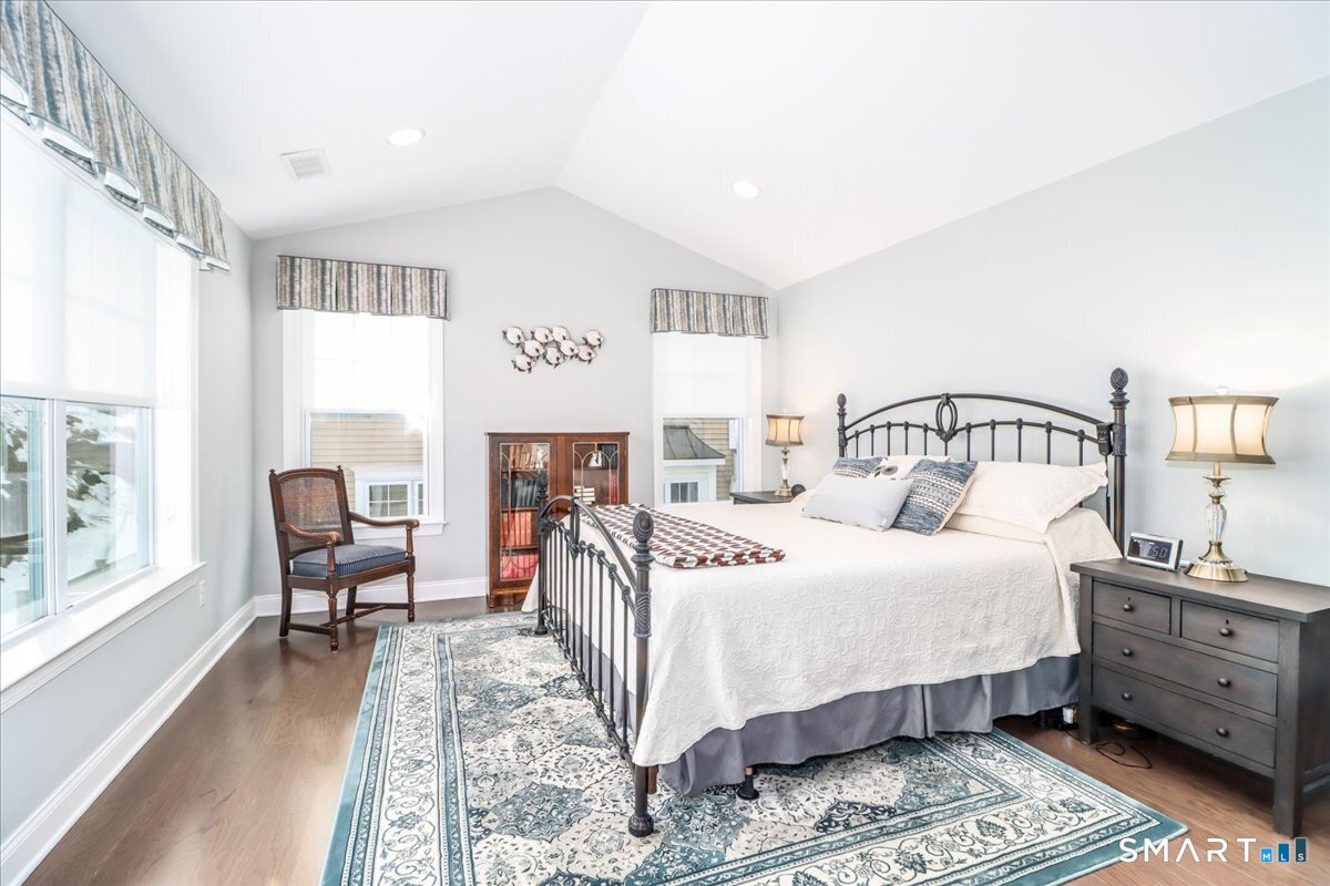 32 Hunting Ridge Lane, Unit 32 Bethel, CT 06801 - Photo 18 of 39 a bedroom with a bed a mirror and a large window