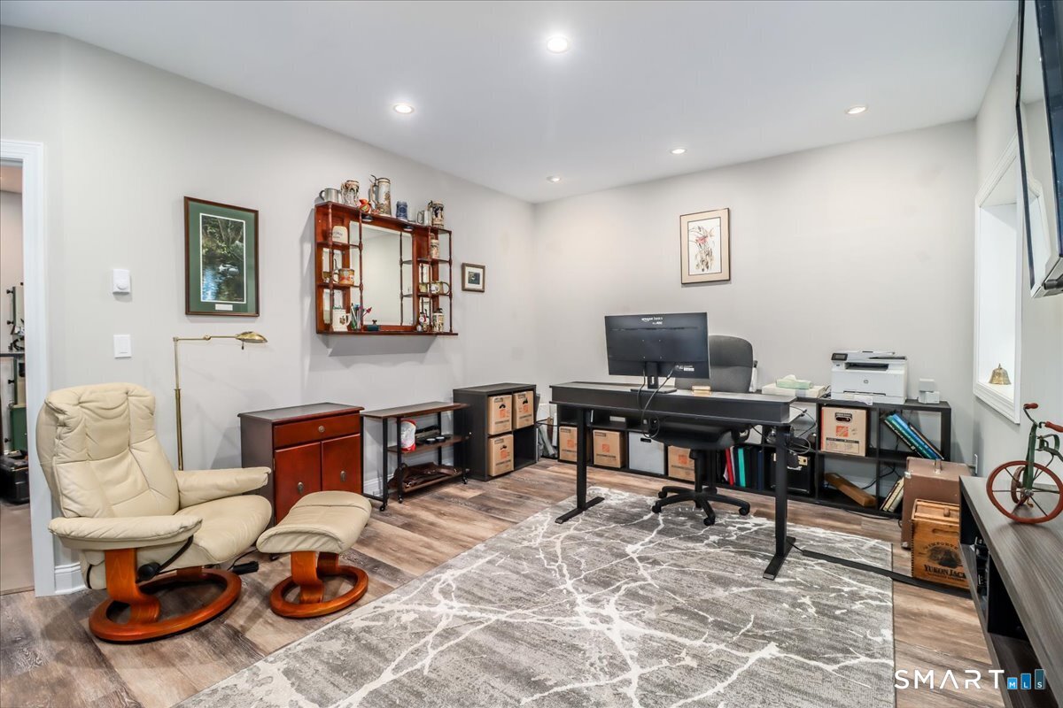 32 Hunting Ridge Lane, Unit 32 Bethel, CT 06801 - Photo 29 of 39 a living room with furniture a piano and a flat screen tv