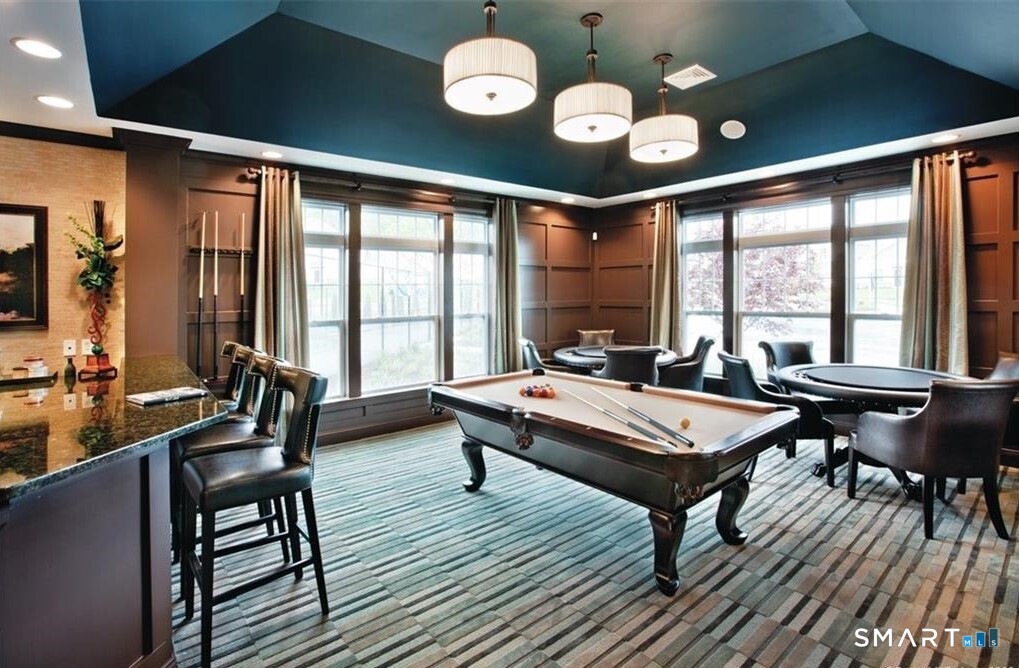 32 Hunting Ridge Lane, Unit 32 Bethel, CT 06801 - Photo 39 of 39 a living room with furniture a fireplace and large windows