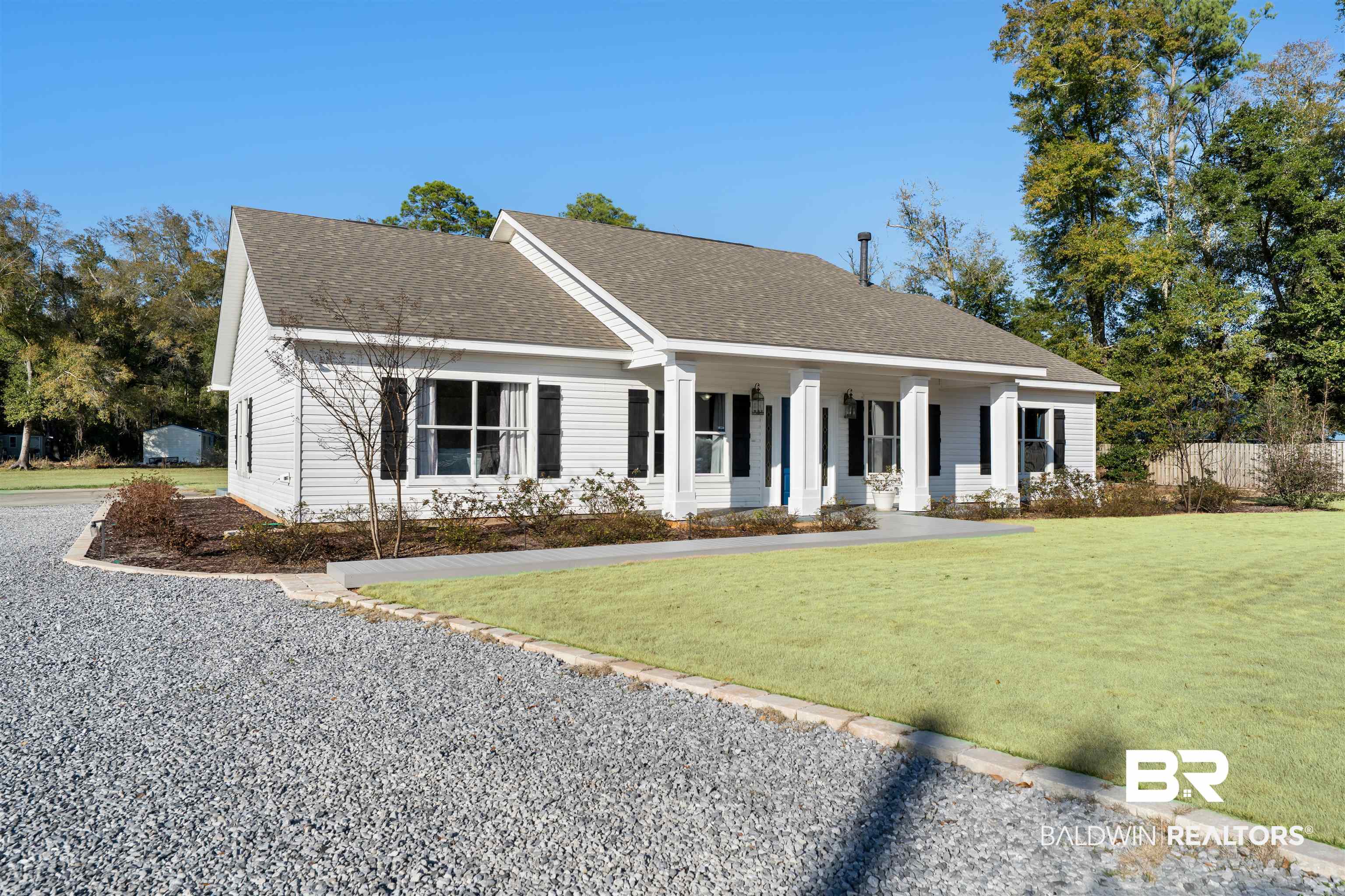 19079 Baldwin County Road 10 Foley, AL 36535 - Photo 1 of 37 View of front of property featuring covered porch, roof with shingles, and a front lawn