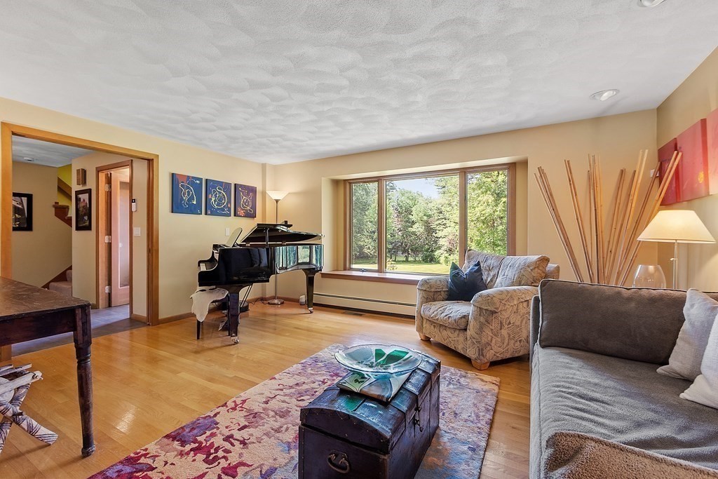 377 Sargent Road Boxborough, MA 01719 - Photo 17 of 42 a living room with furniture and a large window