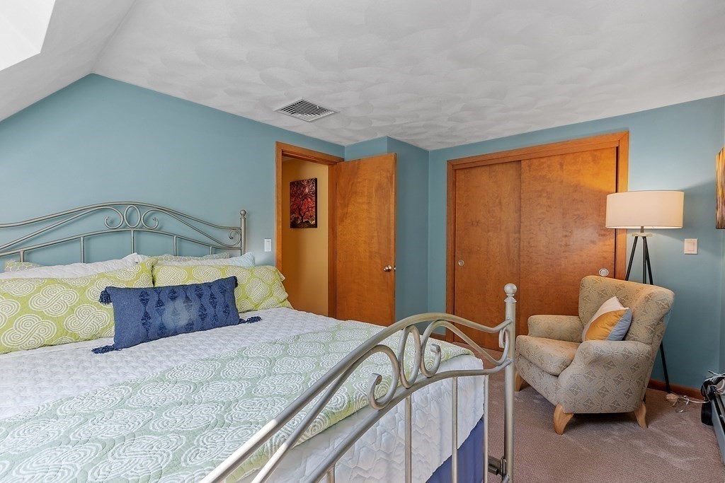 377 Sargent Road Boxborough, MA 01719 - Photo 32 of 42 a bedroom with a bed and a chandelier