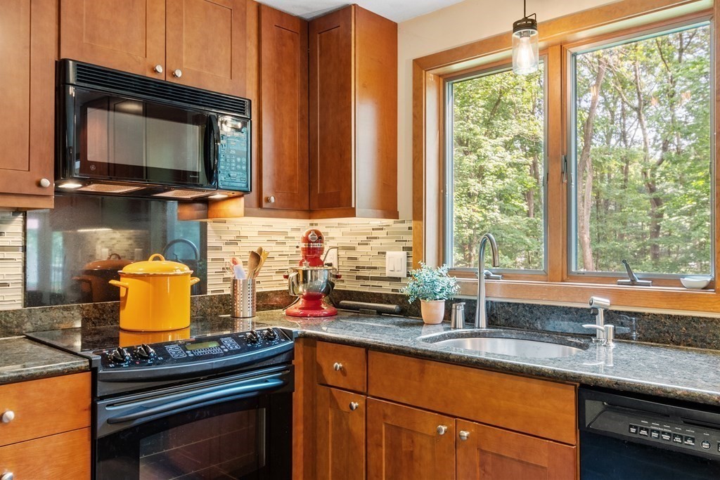 377 Sargent Road Boxborough, MA 01719 - Photo 6 of 42 a kitchen with granite countertop a stove sink and microwave