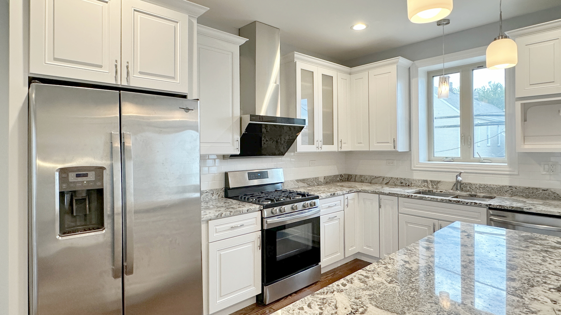 1538 West 34th Street, Unit E Chicago, IL 60608 - Photo 11 of 33 a kitchen with stainless steel appliances granite countertop a stove a refrigerator and a sink