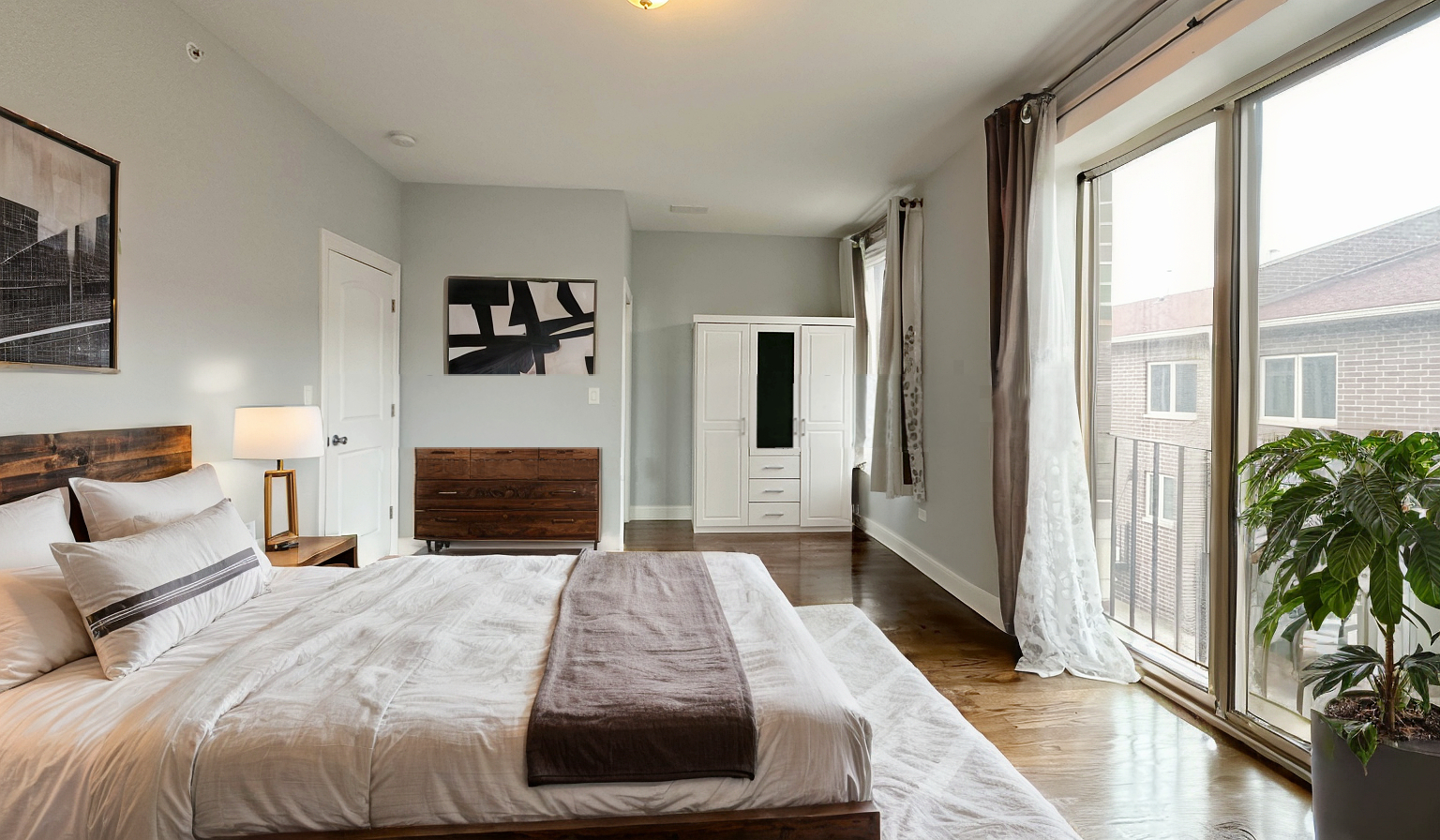 1538 West 34th Street, Unit E Chicago, IL 60608 - Photo 14 of 33 a bedroom with a large bed and a couch