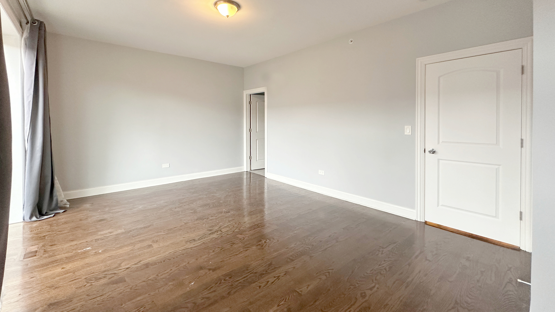 1538 West 34th Street, Unit E Chicago, IL 60608 - Photo 15 of 33 an empty room with wooden floor and windows