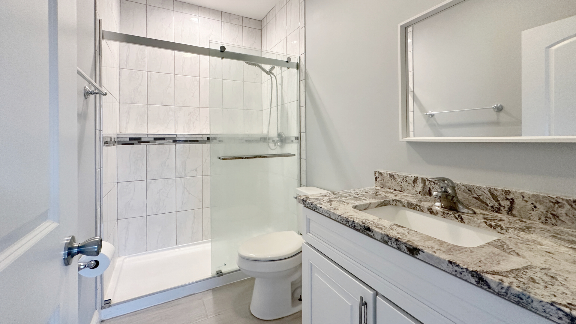 1538 West 34th Street, Unit E Chicago, IL 60608 - Photo 16 of 33 a bathroom with a granite countertop sink a toilet and shower