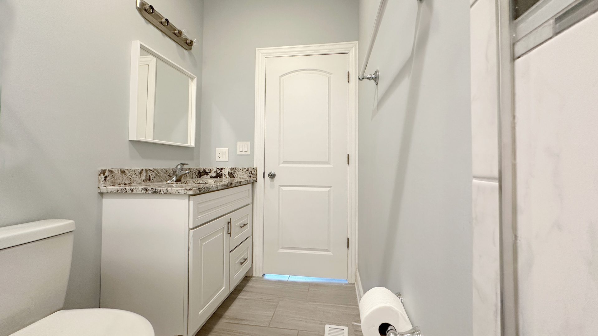 1538 West 34th Street, Unit E Chicago, IL 60608 - Photo 17 of 33 a bathroom with a granite countertop sink toilet and shower