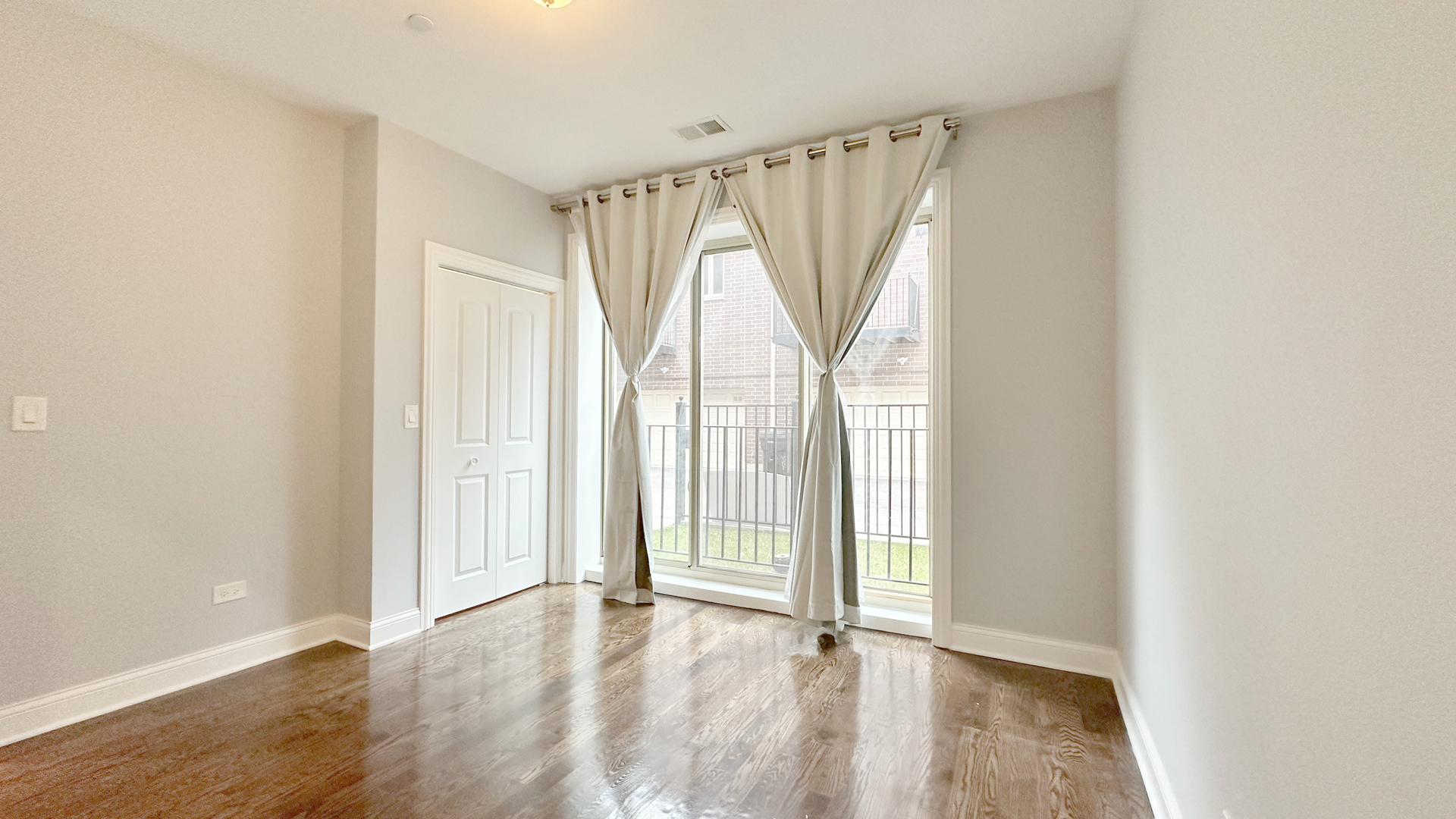 1538 West 34th Street, Unit E Chicago, IL 60608 - Photo 18 of 33 a view of an empty room with wooden floor and a window