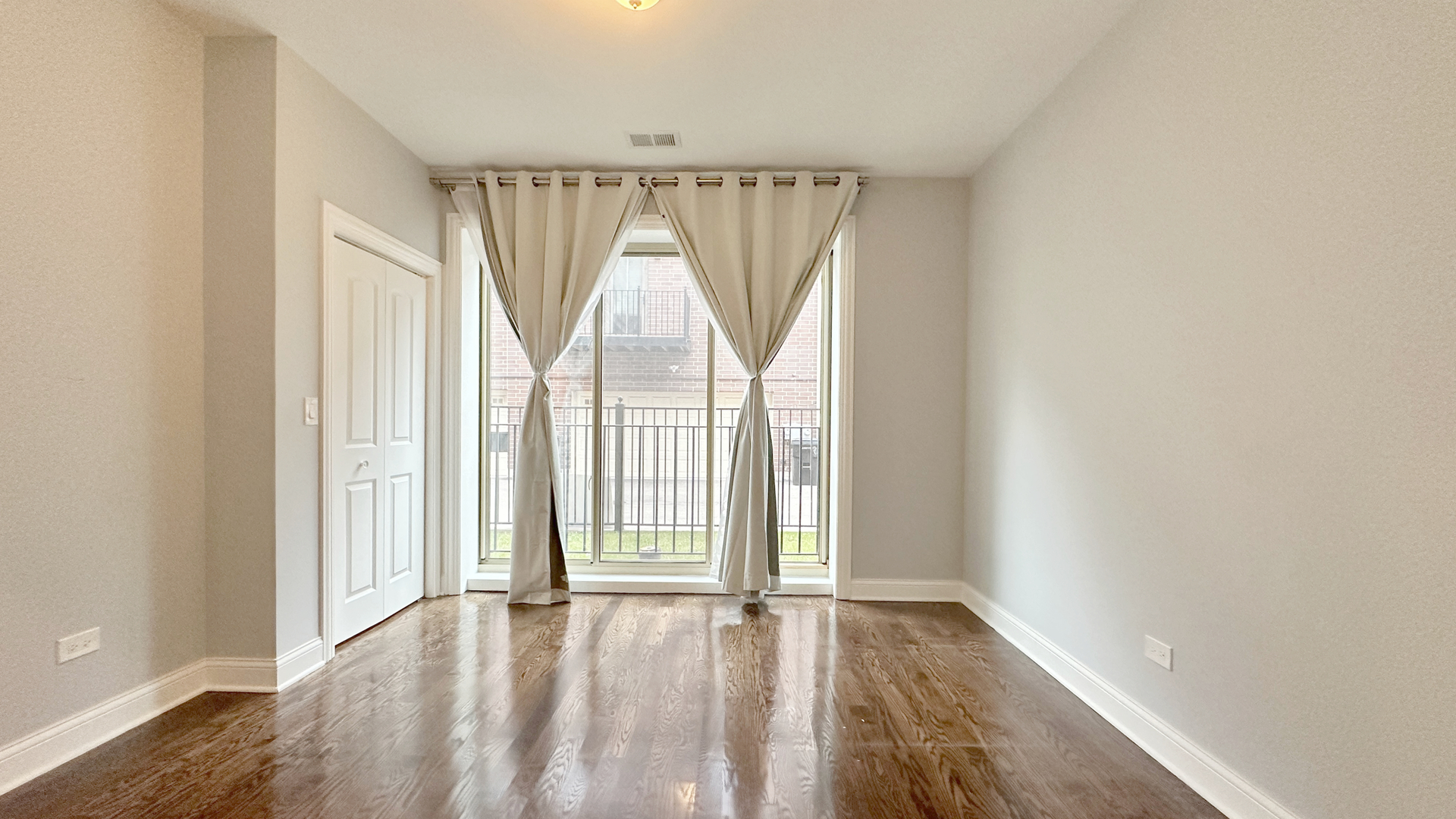 1538 West 34th Street, Unit E Chicago, IL 60608 - Photo 20 of 33 an empty room with wooden floor and windows