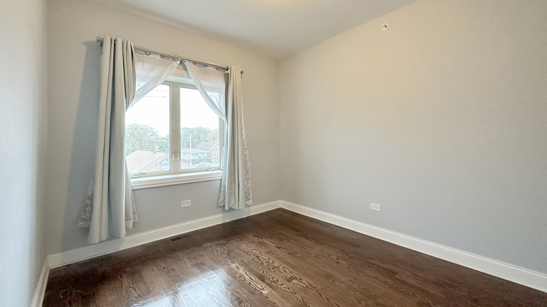 1538 West 34th Street, Unit E Chicago, IL 60608 - Photo 22 of 33 an empty room with wooden floor and windows