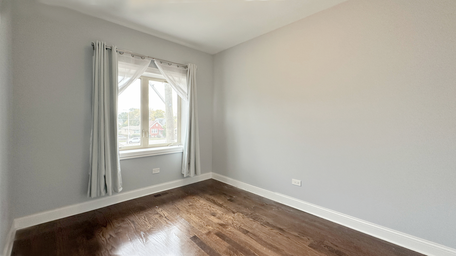 1538 West 34th Street, Unit E Chicago, IL 60608 - Photo 25 of 33 an empty room with wooden floor and windows