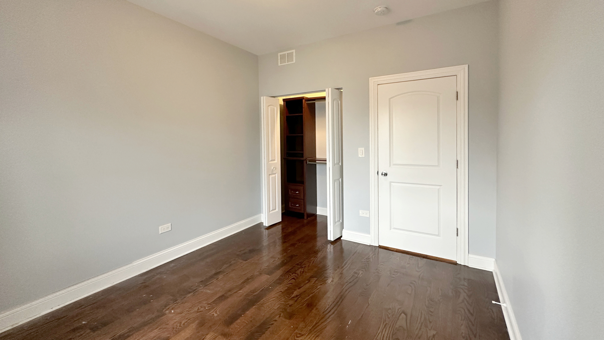 1538 West 34th Street, Unit E Chicago, IL 60608 - Photo 27 of 33 a view of an empty room with wooden floor