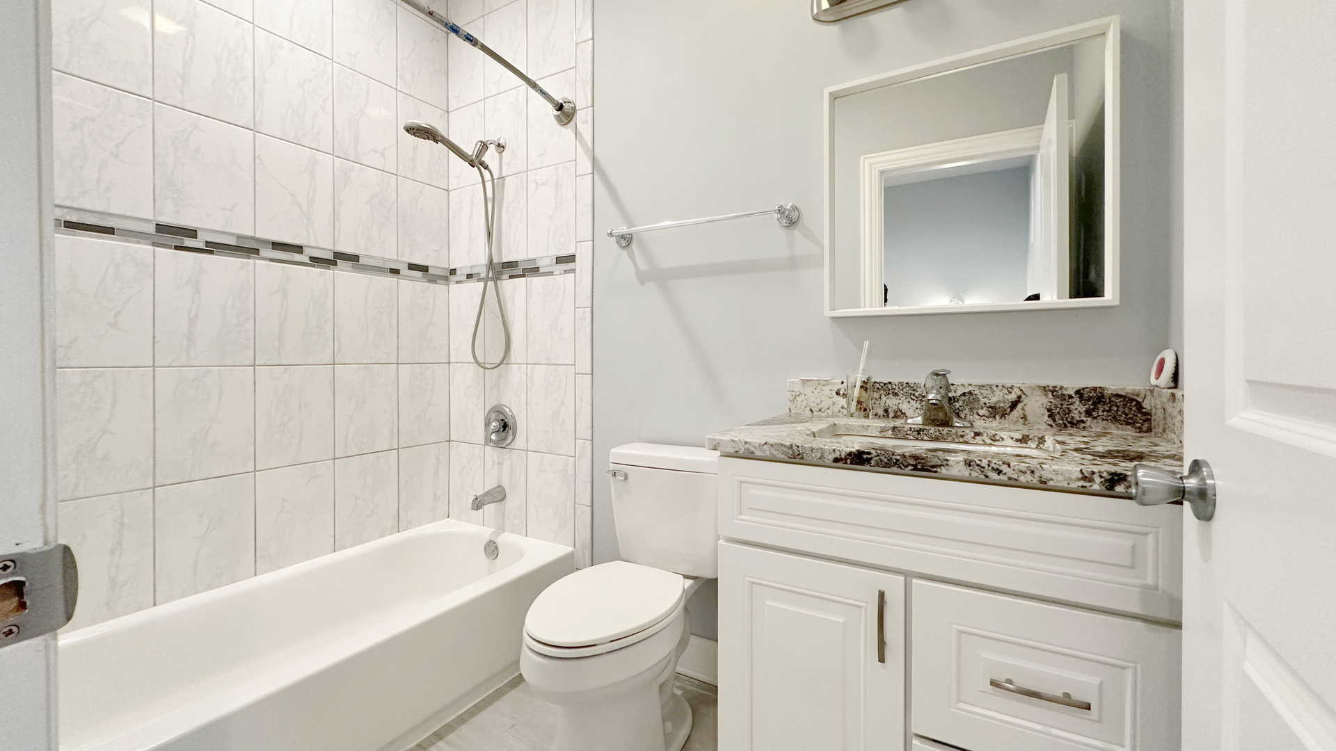 1538 West 34th Street, Unit E Chicago, IL 60608 - Photo 28 of 33 a bathroom with a sink toilet vanity and shower