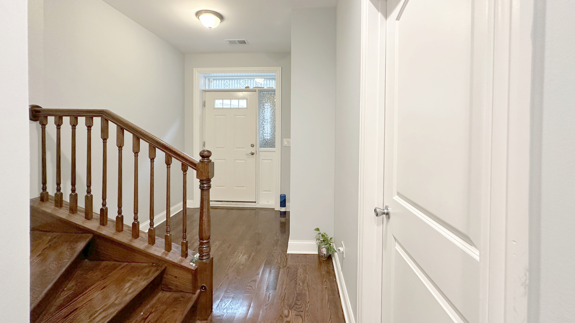1538 West 34th Street, Unit E Chicago, IL 60608 - Photo 5 of 33 a view of a hallway with wooden floor and staircase