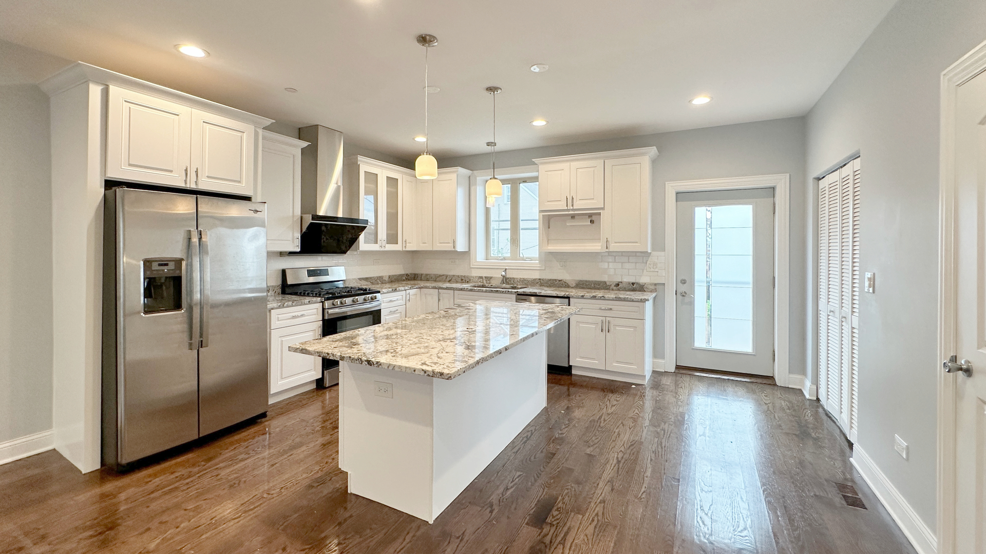 1538 West 34th Street, Unit E Chicago, IL 60608 - Photo 10 of 33 a kitchen with white cabinets and stainless steel appliances