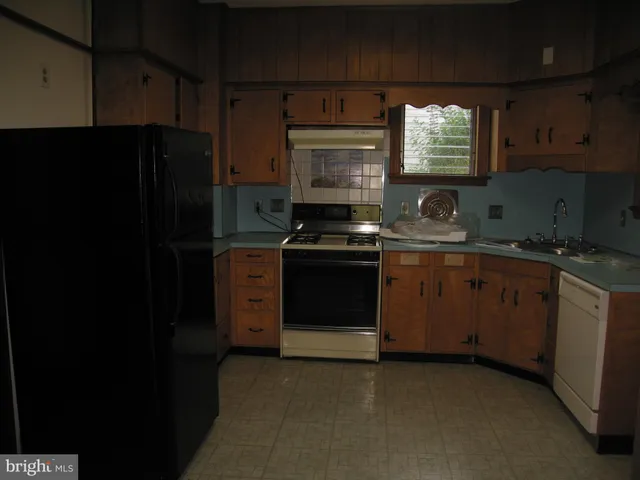 a kitchen with a sink stove and refrigerator