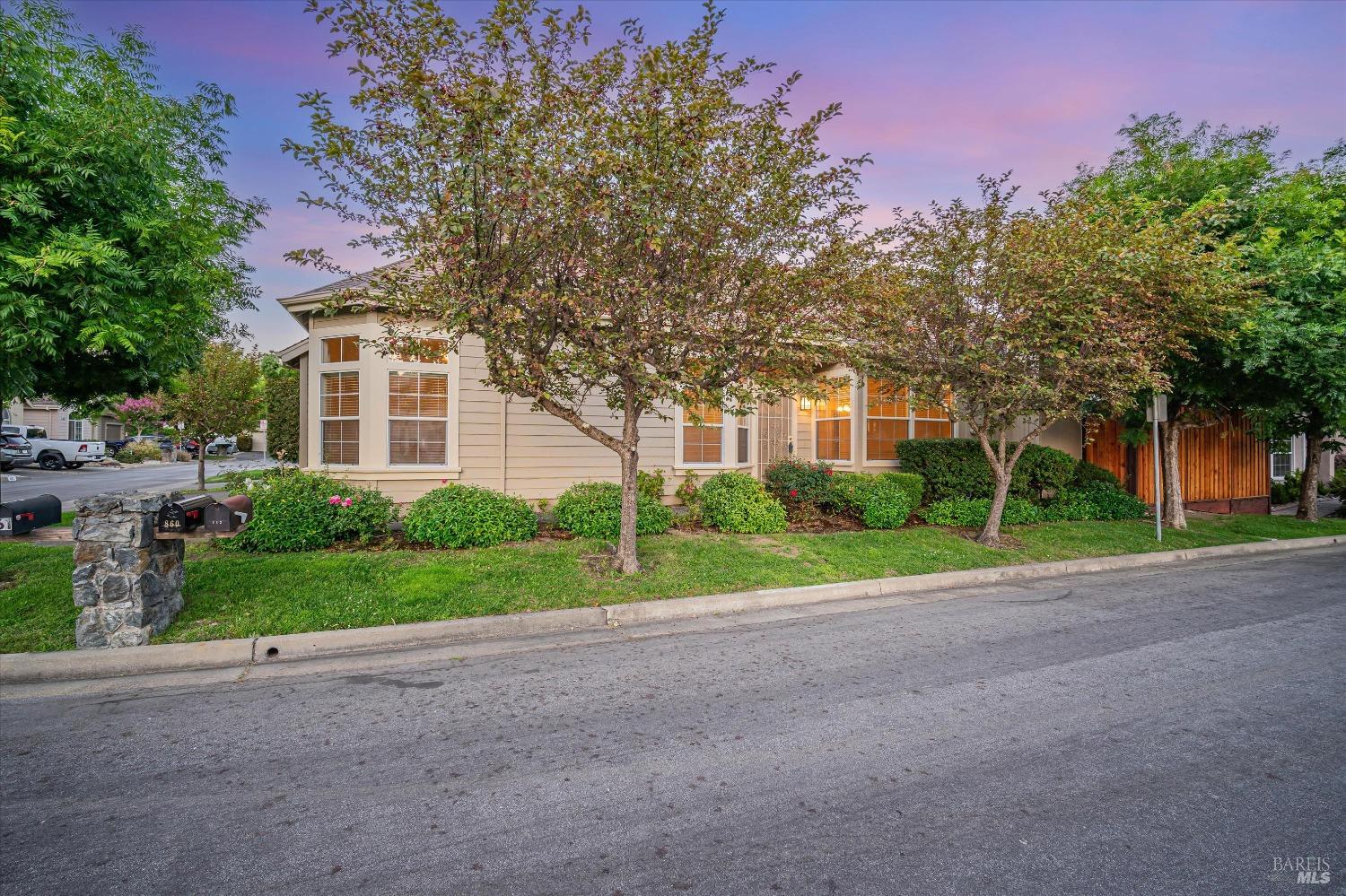 a view of a house with a yard and tree s