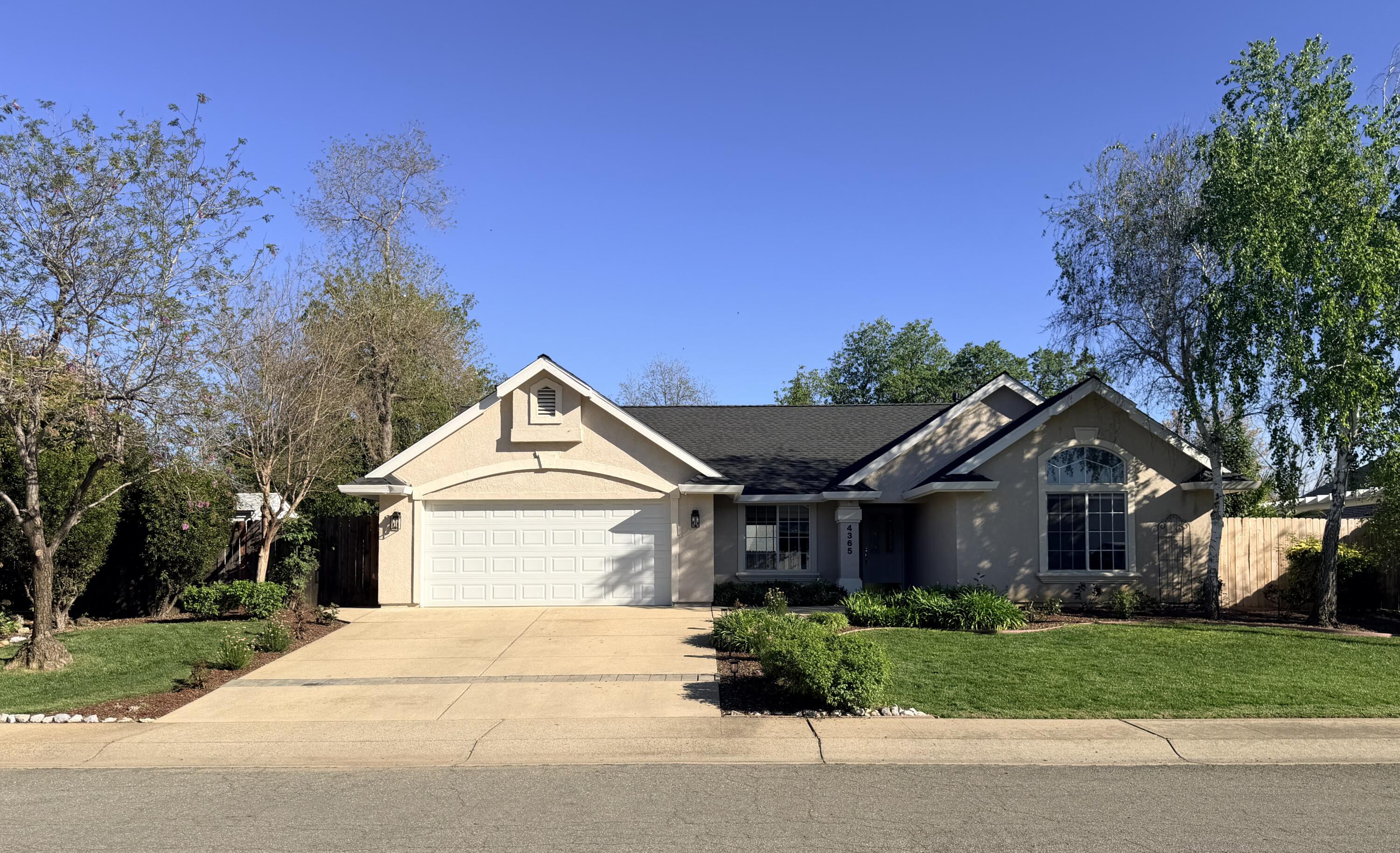 4365 Heather Ridge Lane Redding, CA 96001 - Photo 1 of 21 a front view of a house with a yard and garage