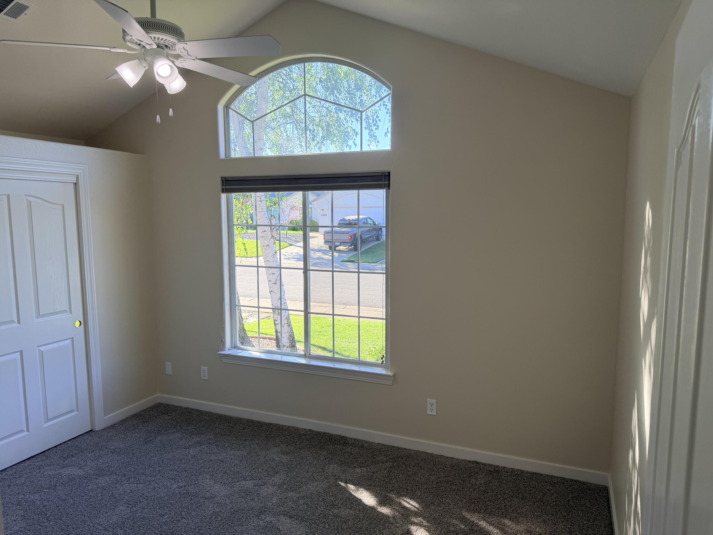 4365 Heather Ridge Lane Redding, CA 96001 - Photo 17 of 21 an empty room with windows chandelier fan and windows
