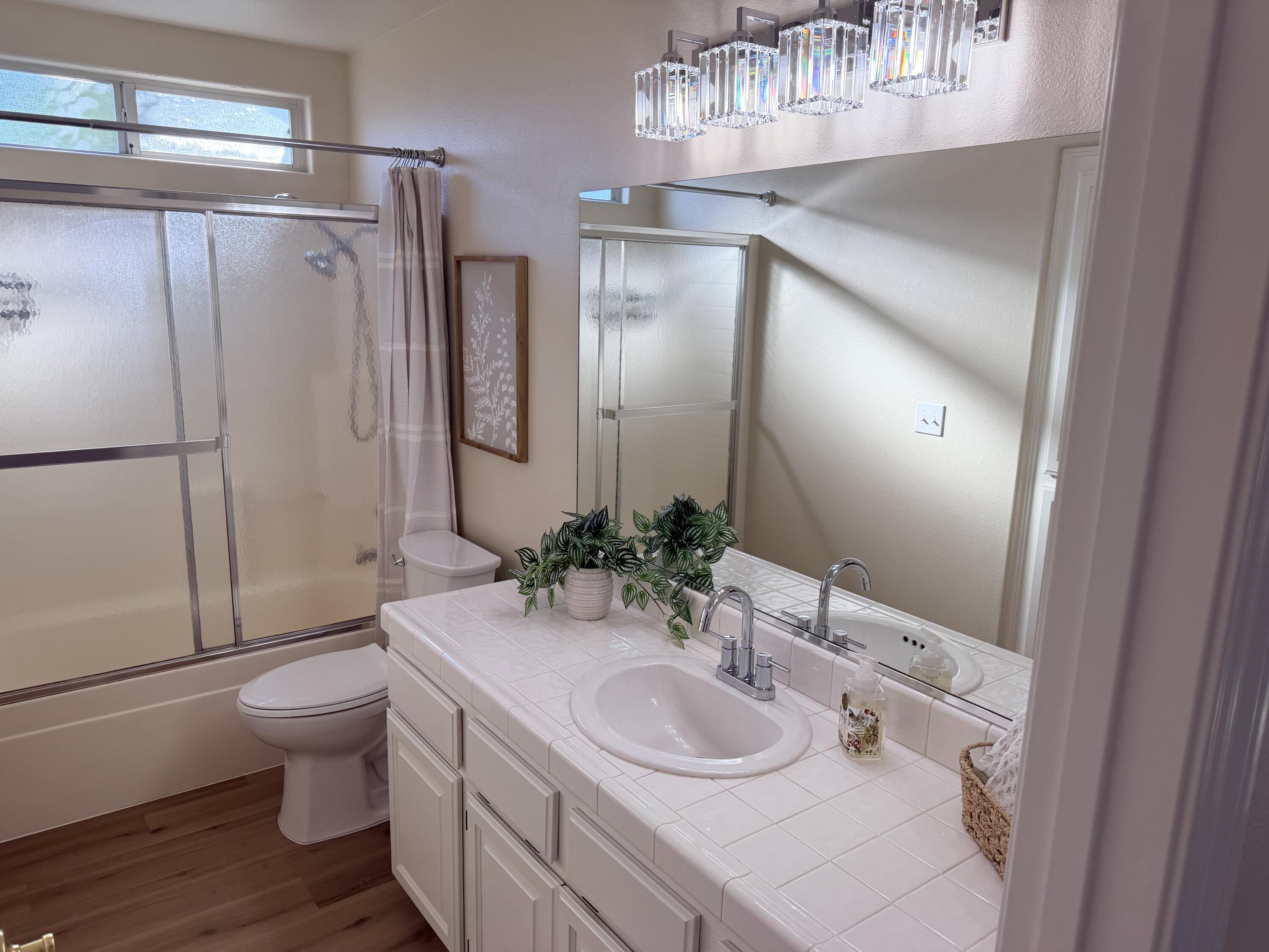 4365 Heather Ridge Lane Redding, CA 96001 - Photo 18 of 21 a bathroom with a sink toilet and shower