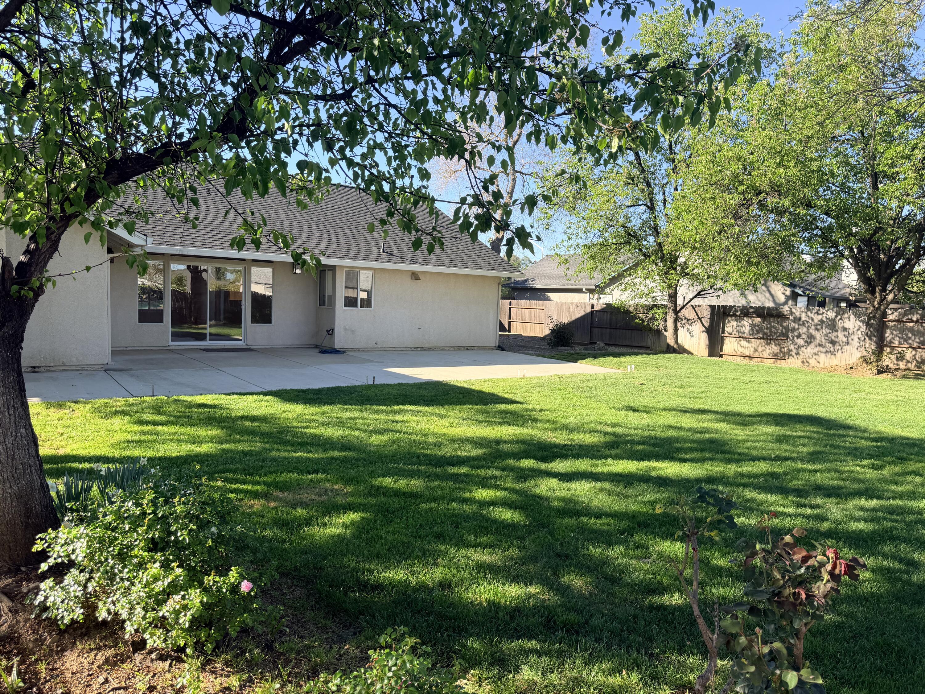 4365 Heather Ridge Lane Redding, CA 96001 - Photo 20 of 21 a view of a house with a big yard and large trees