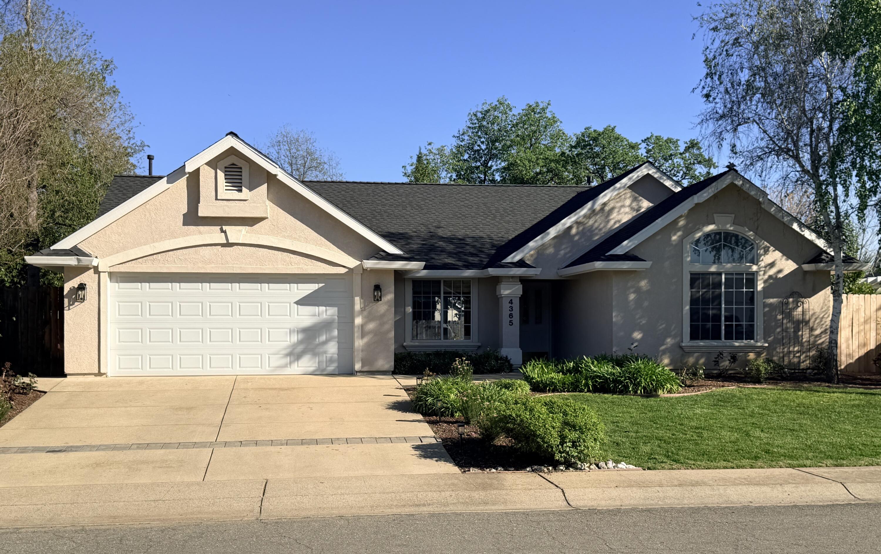 4365 Heather Ridge Lane Redding, CA 96001 - Photo 2 of 21 a front view of a house with a yard and garage