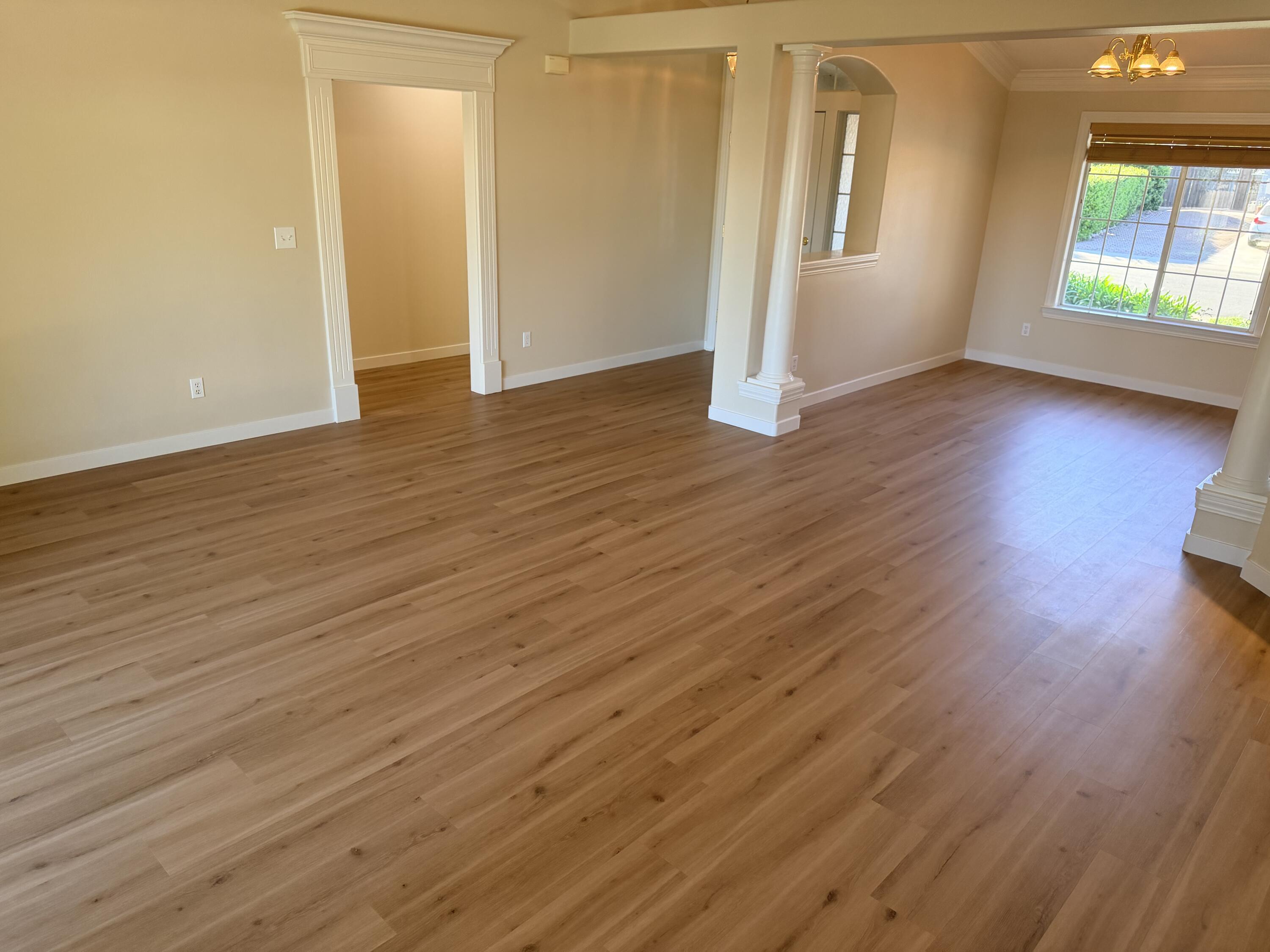 4365 Heather Ridge Lane Redding, CA 96001 - Photo 3 of 21 an empty room with wooden floor and windows