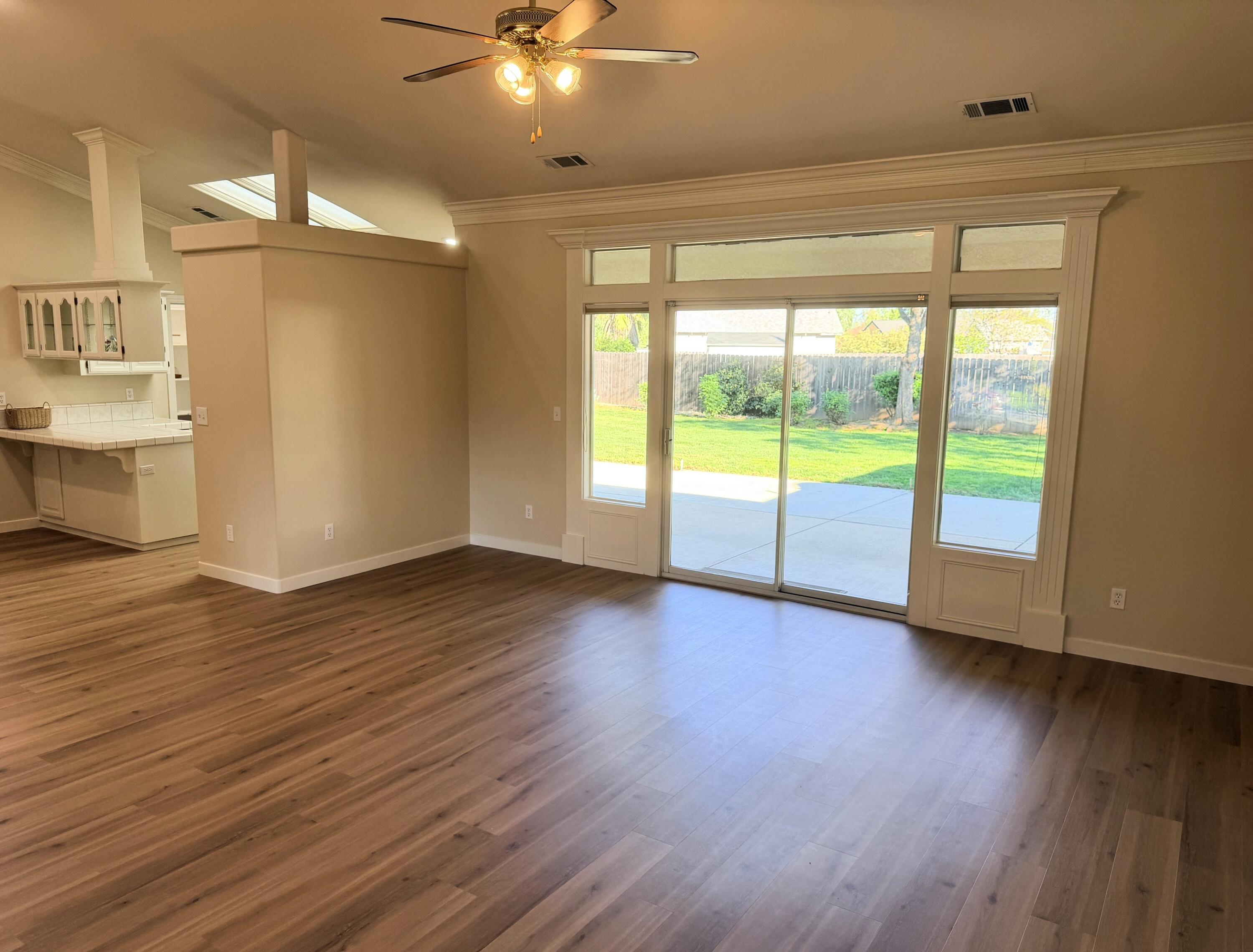 4365 Heather Ridge Lane Redding, CA 96001 - Photo 5 of 21 a view of an empty room with wooden floor and a window