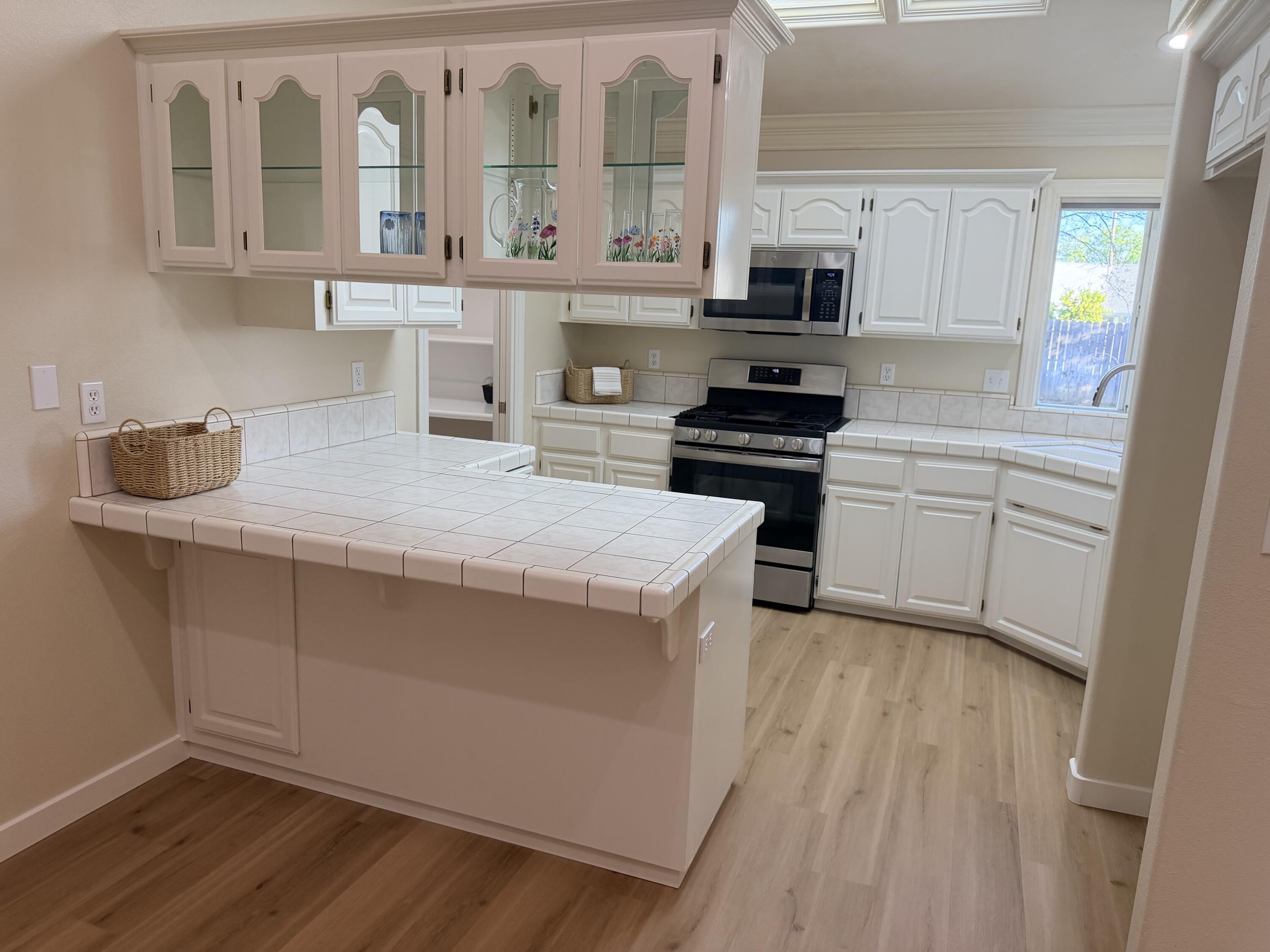 4365 Heather Ridge Lane Redding, CA 96001 - Photo 7 of 21 a kitchen with granite countertop a stove and a sink