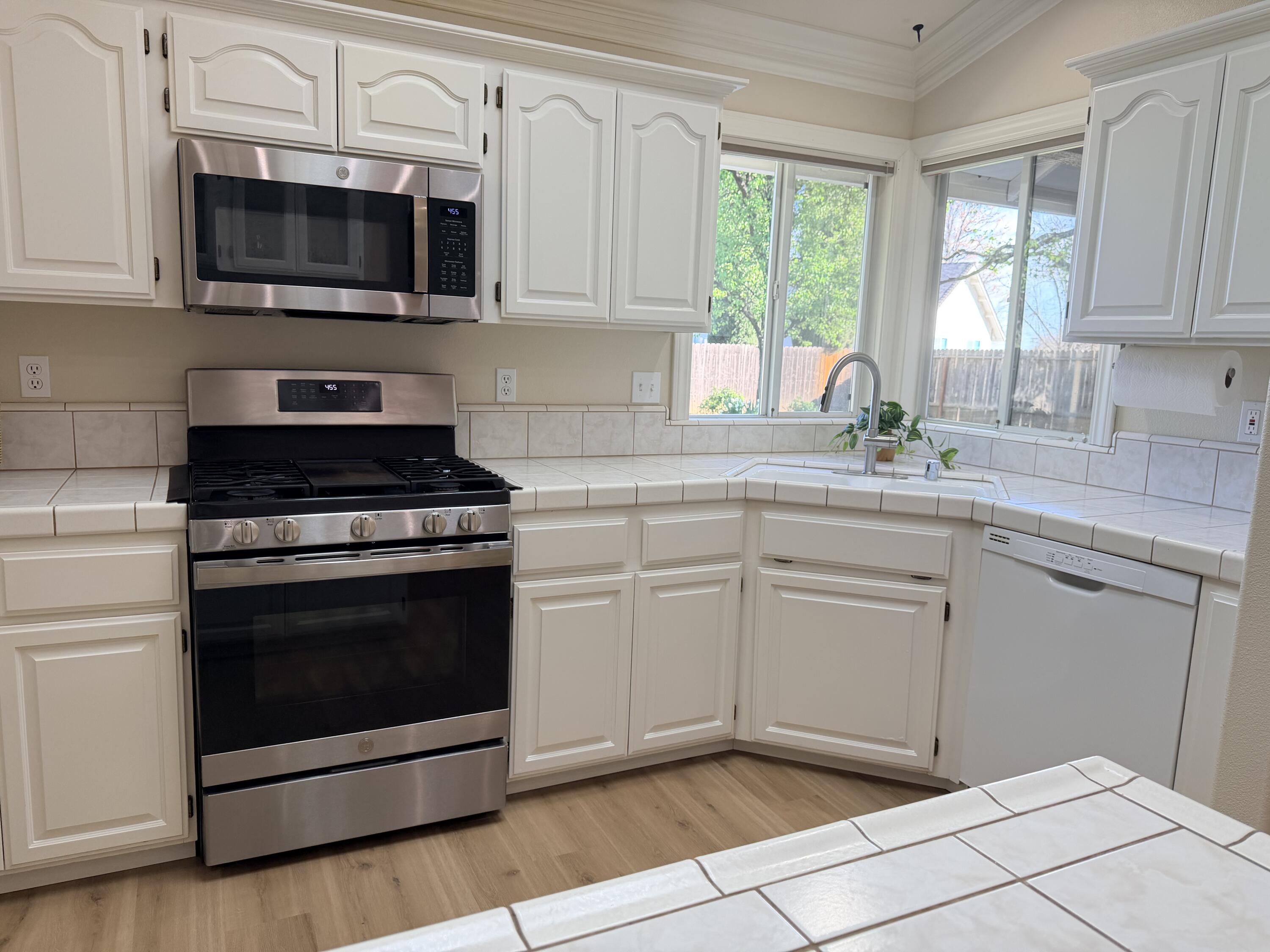 4365 Heather Ridge Lane Redding, CA 96001 - Photo 8 of 21 a kitchen with cabinets stainless steel appliances and window