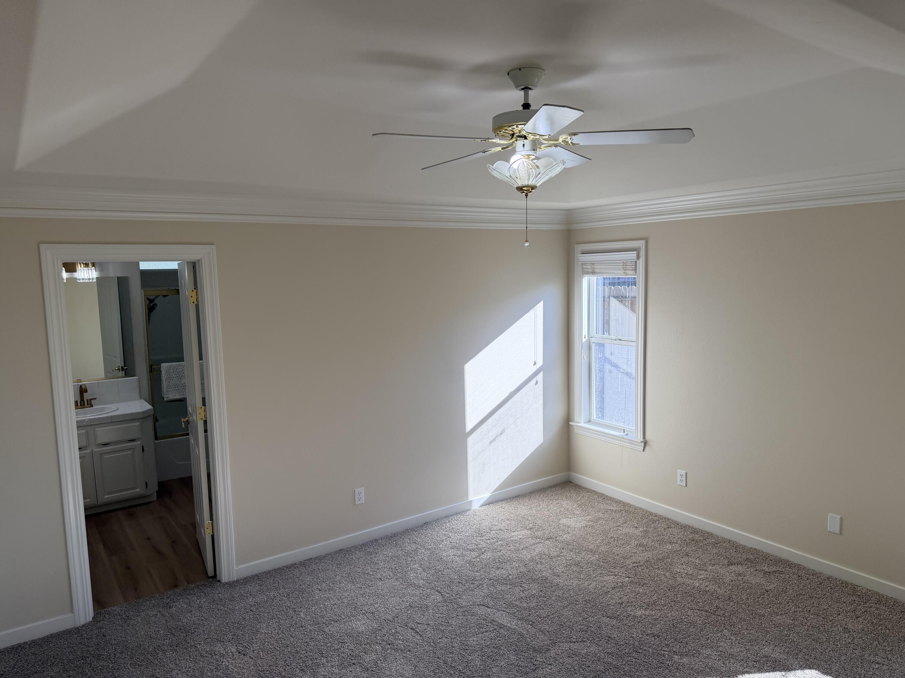 4365 Heather Ridge Lane Redding, CA 96001 - Photo 10 of 21 an empty room with chandelier fan and windows